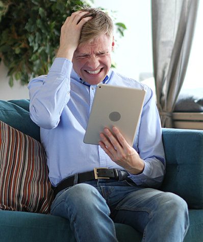 Man Using Tablet Reacting to Financial Loss