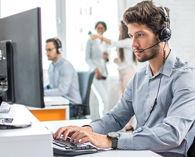 male customer support phone operator with headset working in call center.